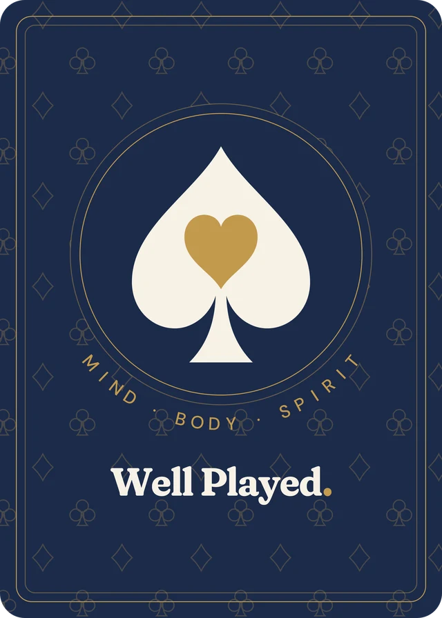 The back of a Well Played card: a cream spade holding a gold heart, ringed by the words Mind, Body, Spirit